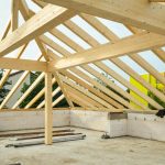 Wooden roof structure in progress with open sky view, ideal for construction themes.