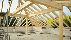 Wooden roof structure in progress with open sky view, ideal for construction themes.